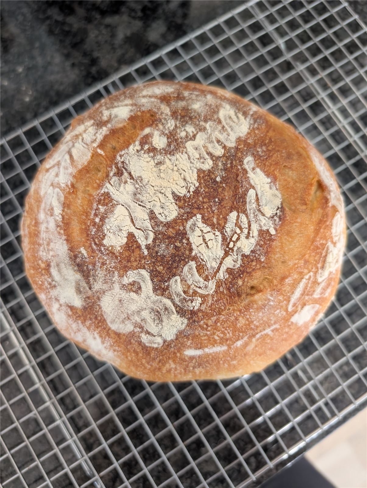 Sourdough loaf with a flour-dusted design on top