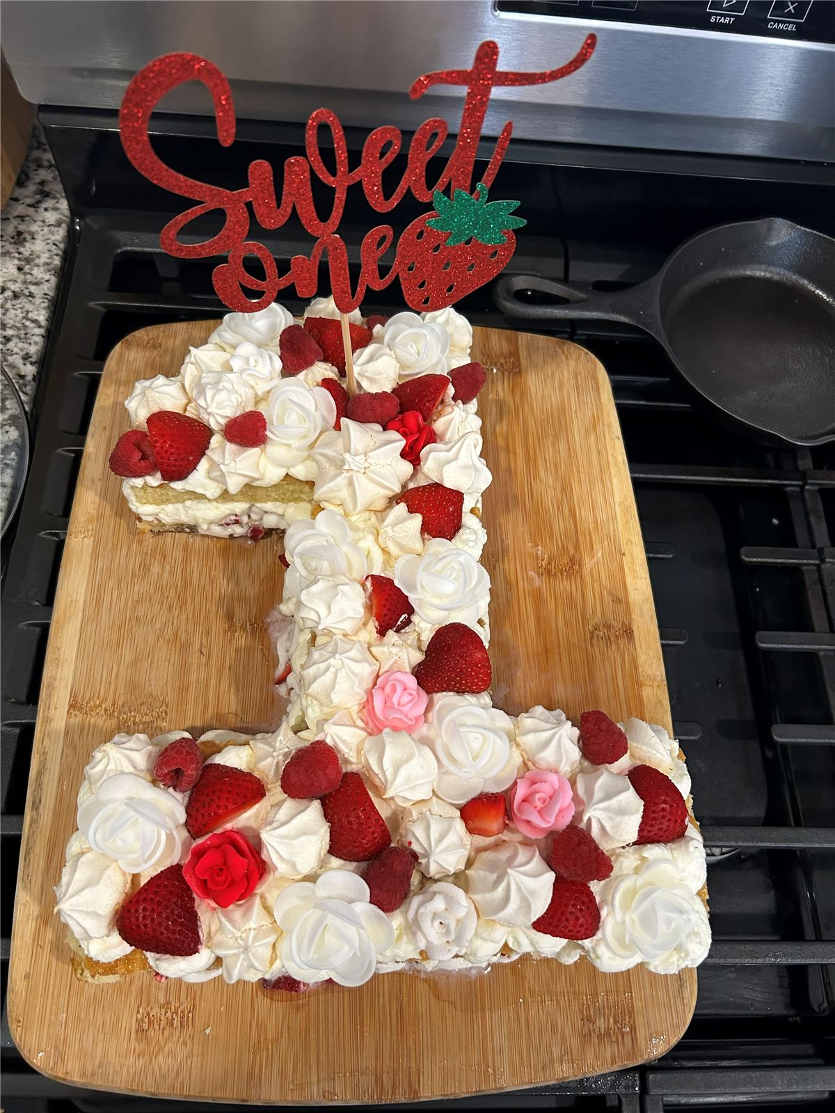 Number 1 birthday cake decorated with berries and flowers