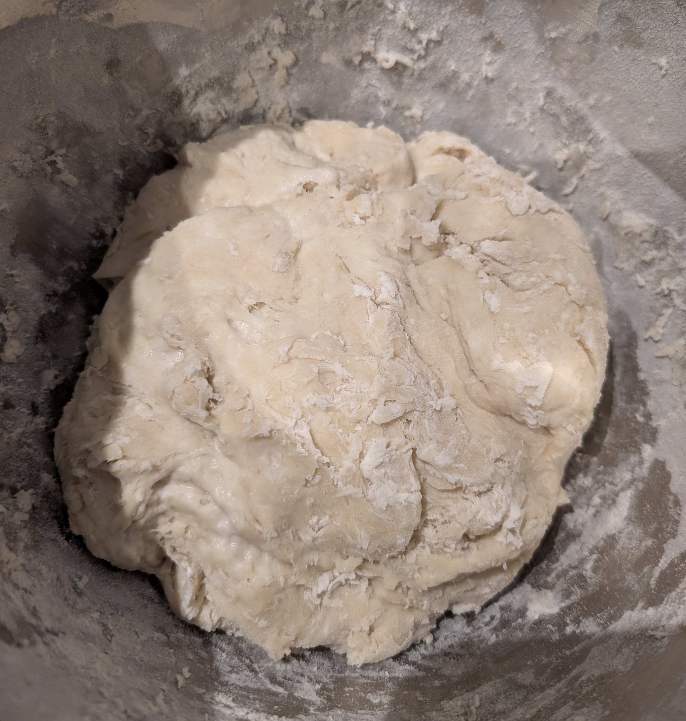 Dough in a mixing bowl after the first stretch and fold, still rough and shaggy