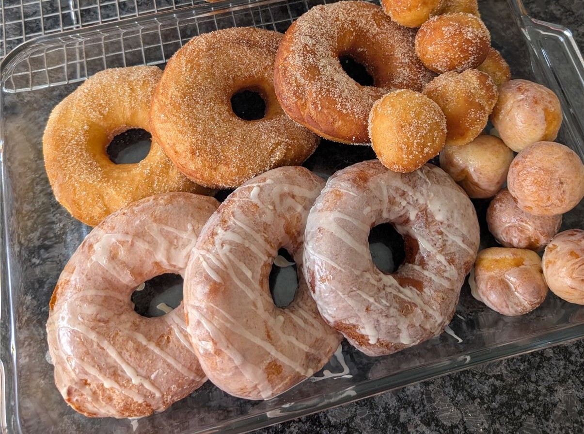 Tray of finished sourdough discard donuts, cinnamon-sugar and glazed