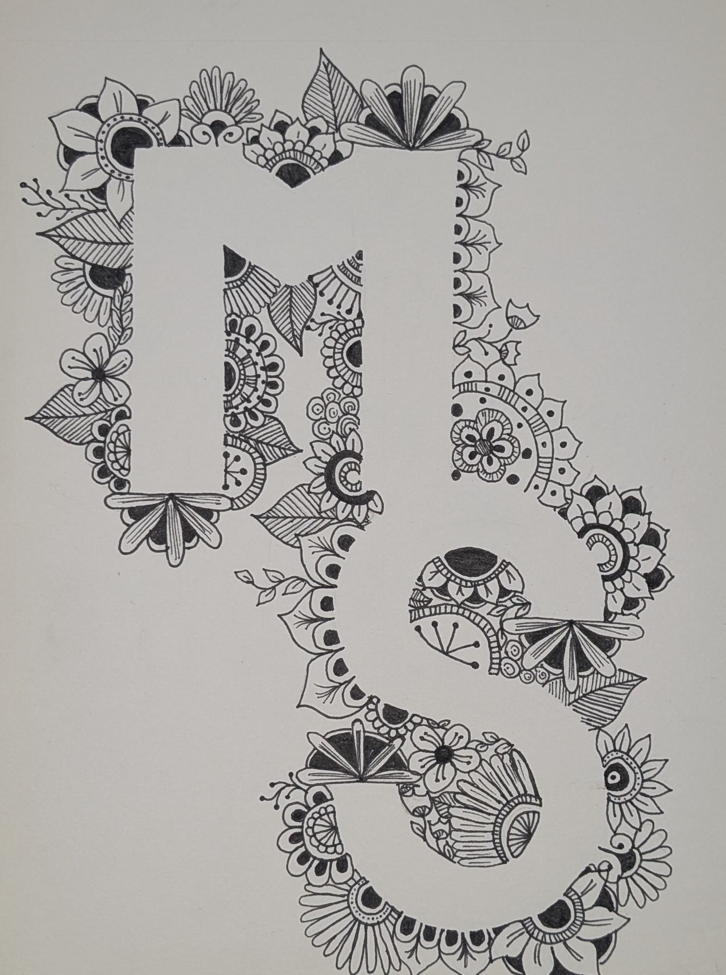 Black ink drawing of the letters M and S filled with floral and mandala doodles