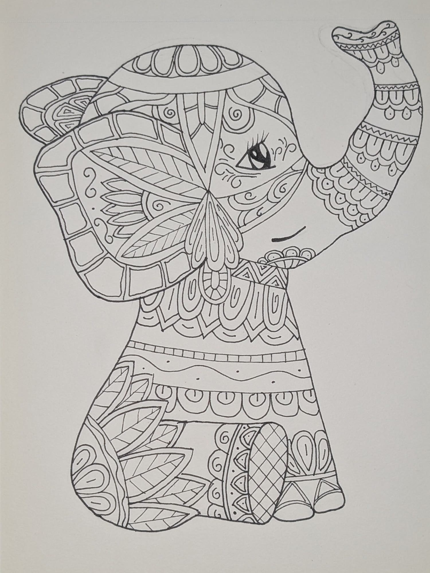 Black ink drawing of a baby elephant with its trunk raised, filled with zentangle patterns
