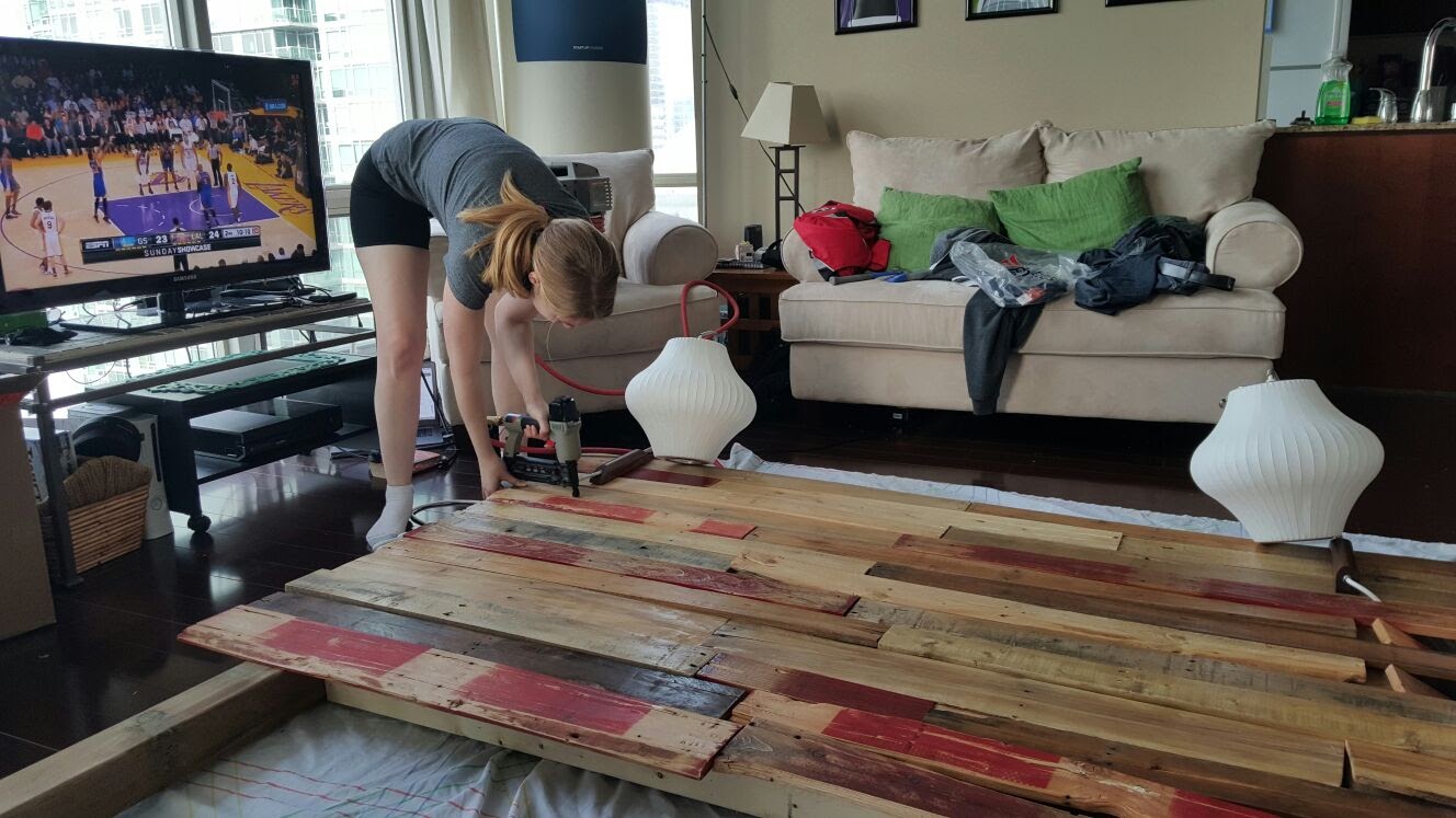 Nailing the reclaimed boards onto the cedar frame with a rented finish nailer