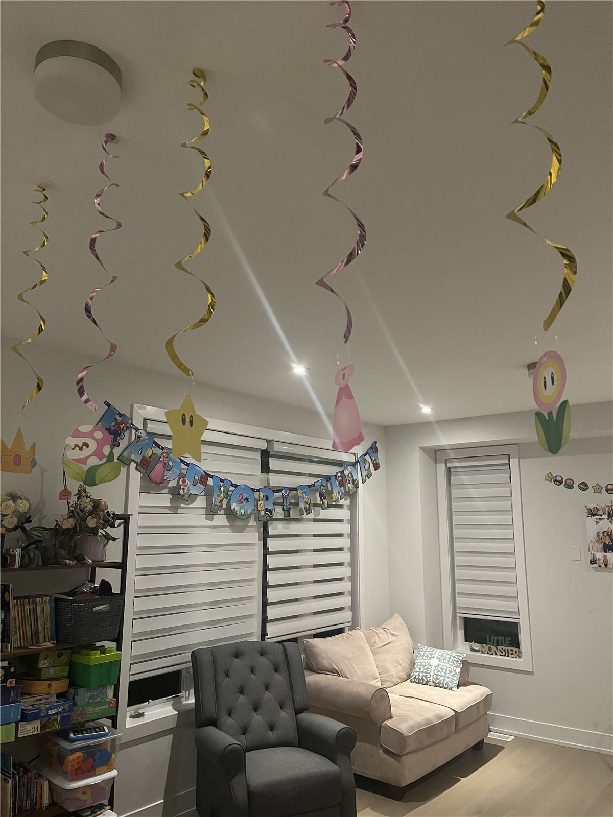 Super Mario party decorations including hanging swirls, a happy birthday banner, and character cutouts