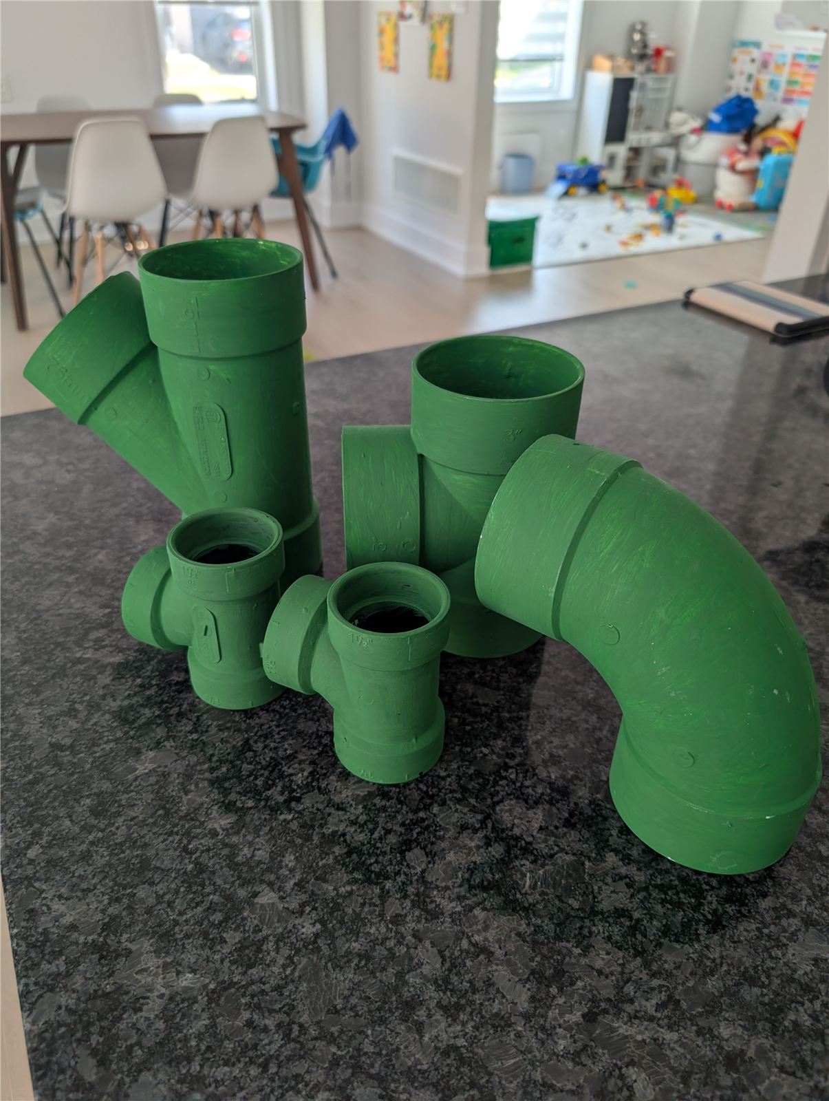 Green painted PVC pipe fittings made to look like Super Mario warp pipes