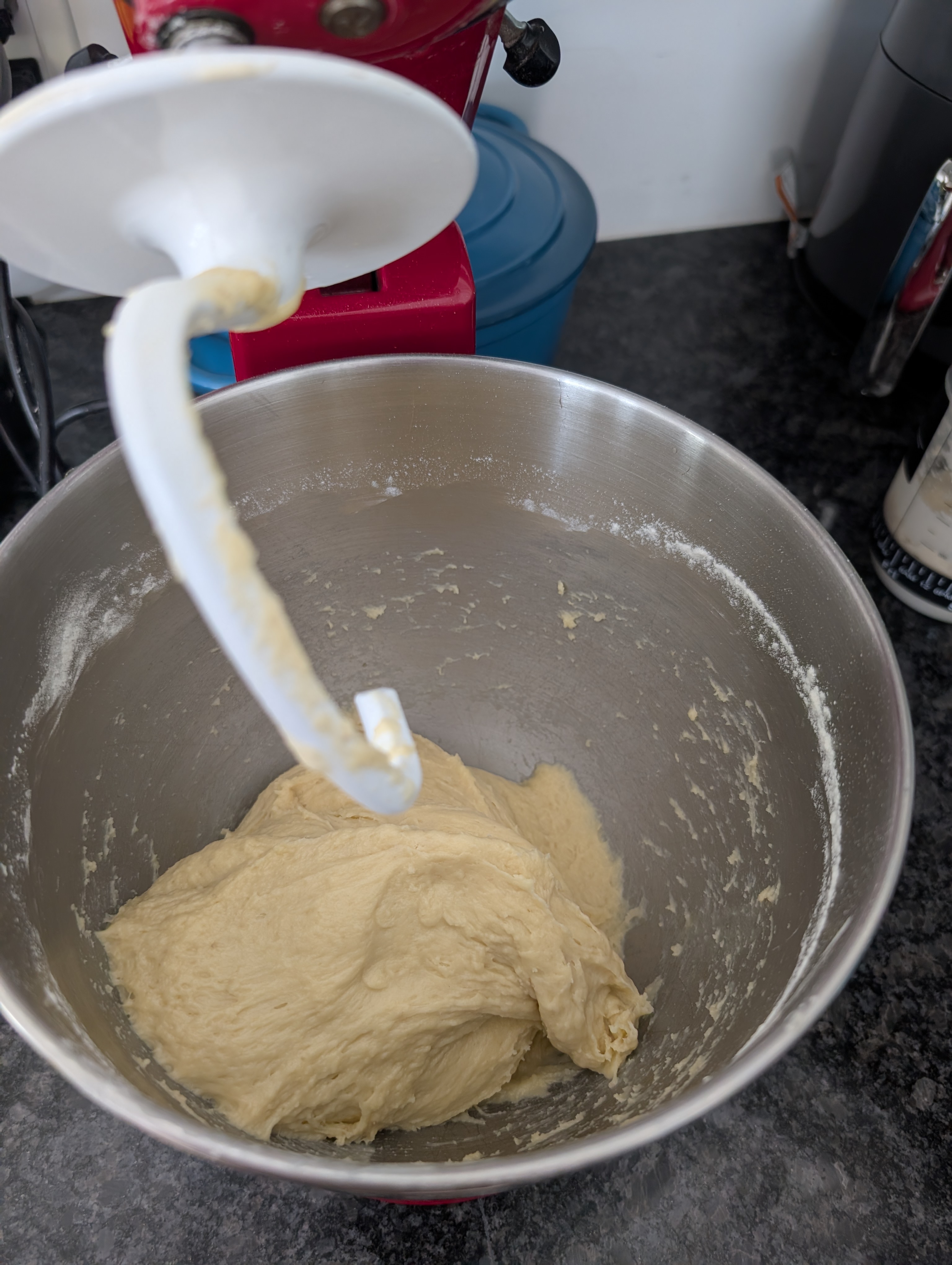 Sourdough pizza dough being mixed in a stand mixer