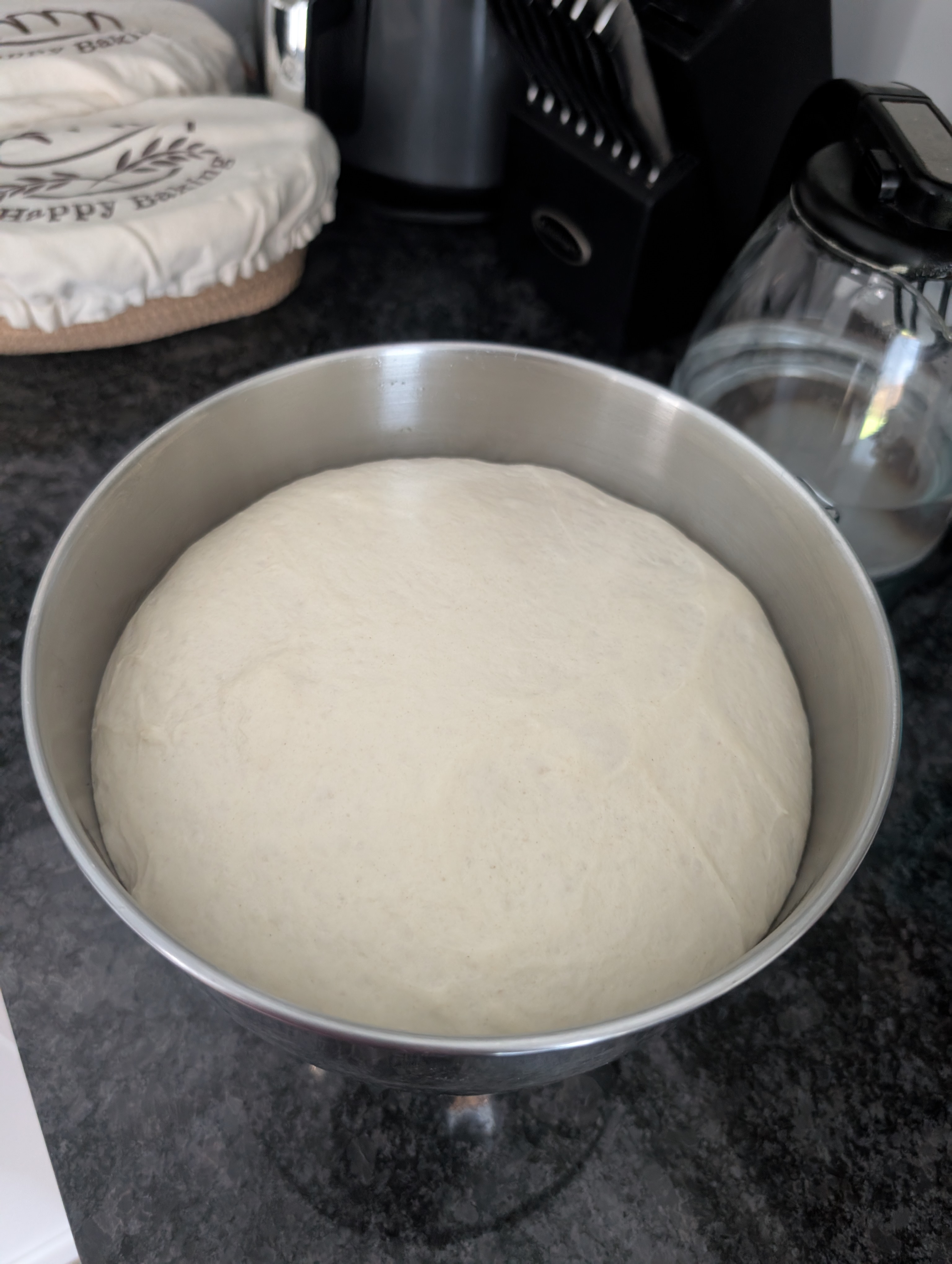 Sourdough pizza dough proofed and doubled in a steel bowl