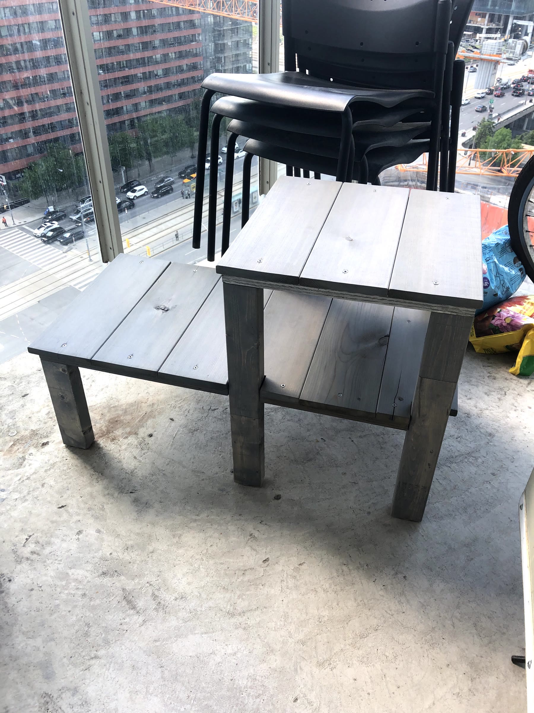 Plant stand stained weathered grey, shown on a balcony before any plants are added
