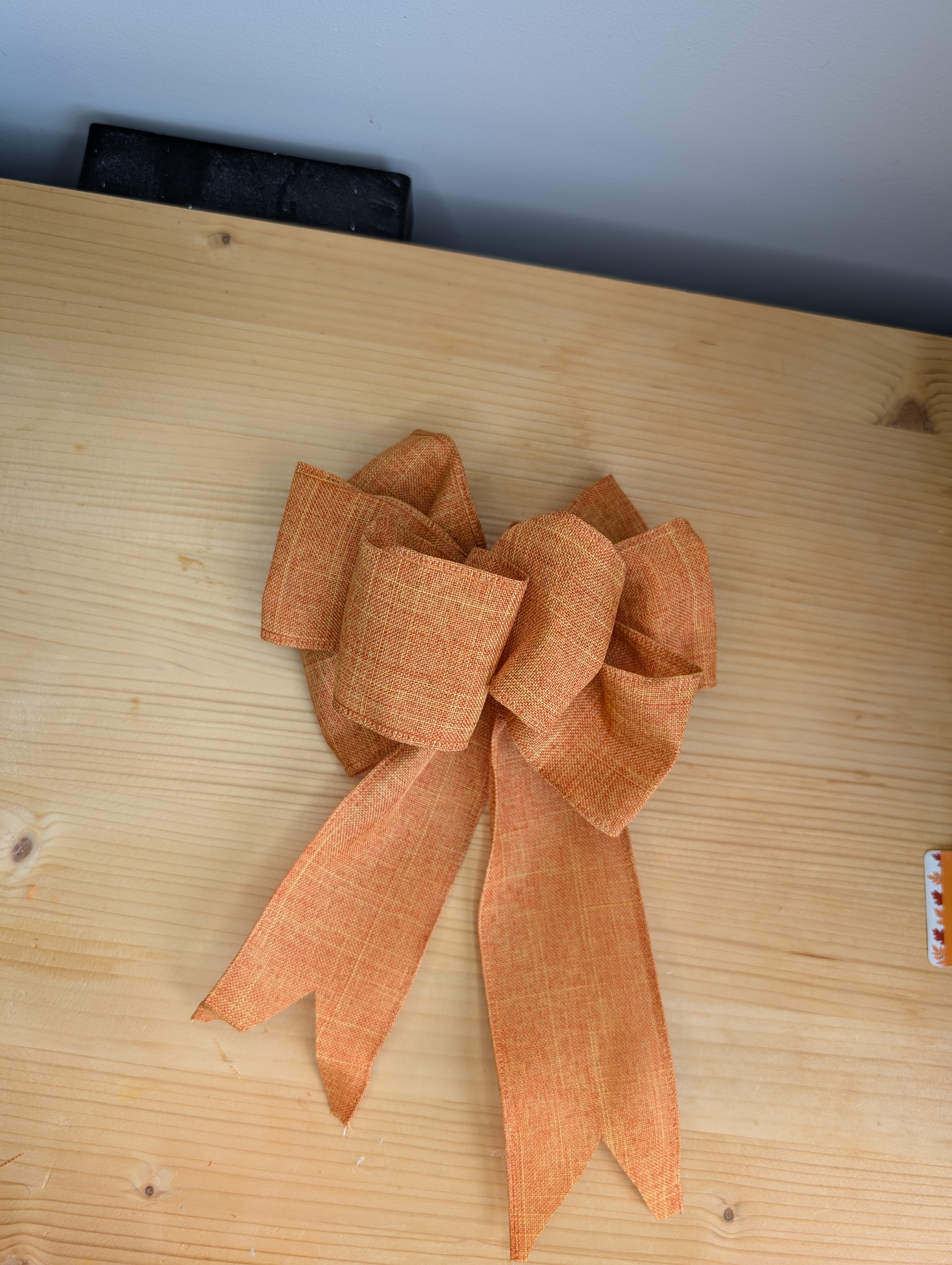 Multi-loop orange ribbon bow made for the wreath